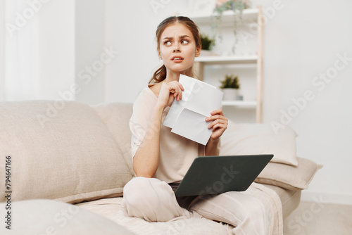 Smiling Woman Typing on Laptop in Cozy Home Office