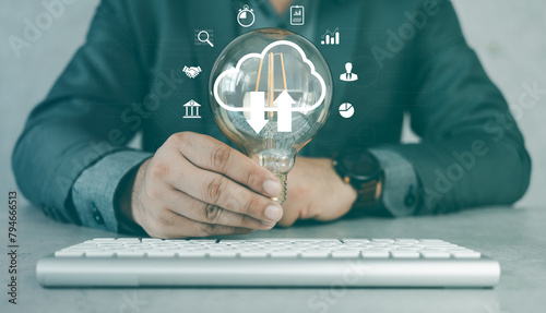 Businessman holding a light bulb and creative light bulb with marketing network icons on planning strategy, analysis solution and development, Modern business, Innovative of new ideas. © Dontree
