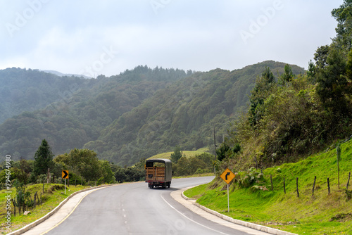 Truck turning a curve on a highway in the Colombian countryside.