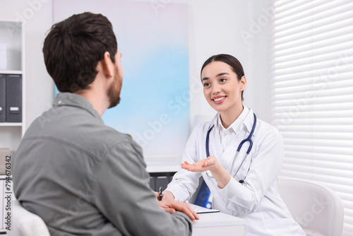 Doctor consulting patient during appointment in clinic