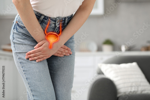 Woman suffering from cystitis at home, closeup. Illustration of urinary system photo