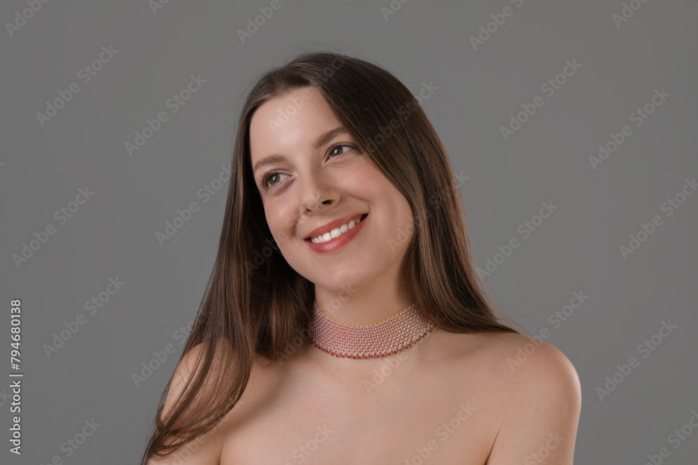 Portrait of beautiful young woman on grey background Portrait of beautiful young woman on grey background
