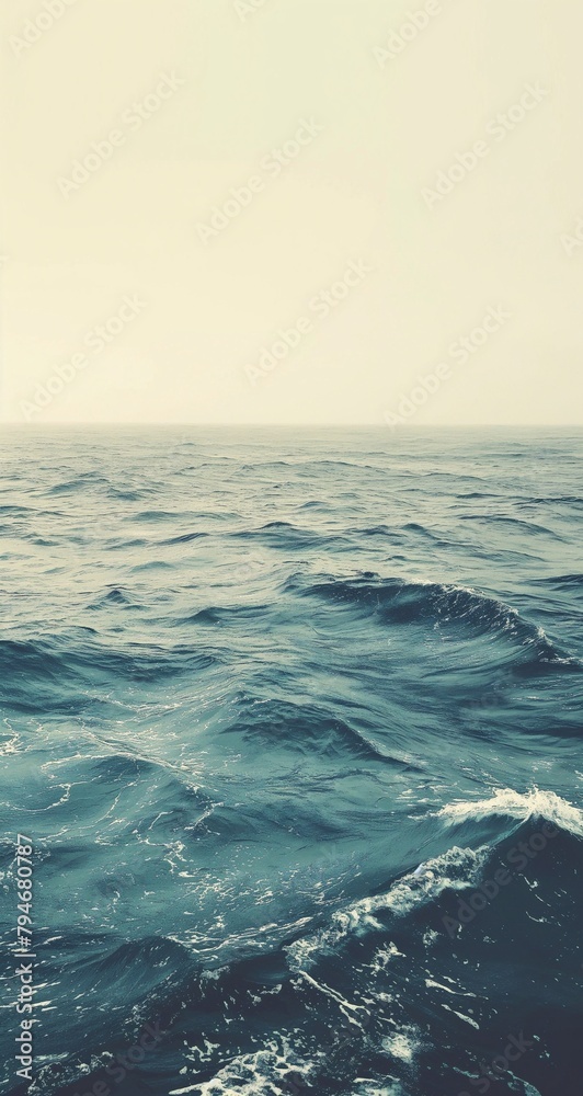 Vast ocean with gentle waves, muted color palette, in the style of vintage photography.