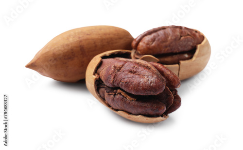 Three tasty pecan nuts isolated on white