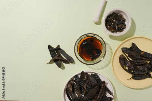 Organic ingredient for hair care product with black locust contained on several type of containers on the left side of photo over white background. Copy space with high angle view photo