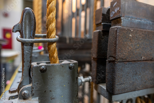 Older theatrical rigging system with twisted manila rope and weights found back stage.