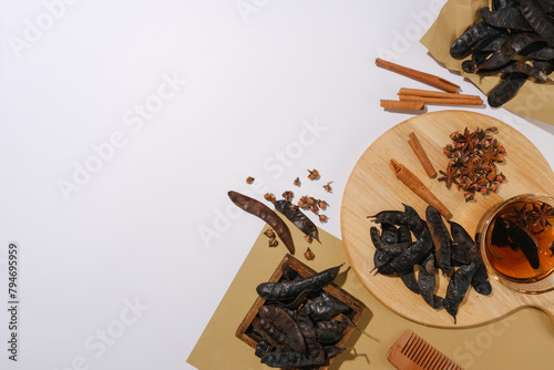 Photo from top view at vintage concept with a wooden tray and some vintage paper contain medicine herbs above. Template for organic product advertise, which has ingredients from nature photo