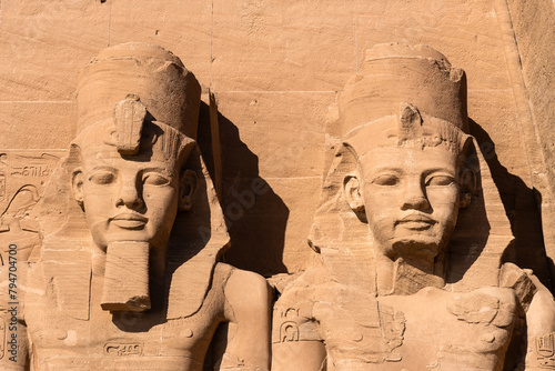 Abu Simbel, Egypt: Exterior view of the majestic statues of Ramses II that ornate the facade of the famous Abu Simbel temple in Upper Egypt.