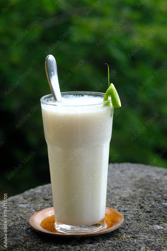 Jus Sirsak, soursop juice in a clear glass. Soursop is a flowering plant that comes from the Caribbean, Central America and South America. Annona muricata. Jus Sirsak, soursop juice in a clear glass. Soursop is a flowering plant that comes from the Caribbean, Central America and South America. Annona muricata.