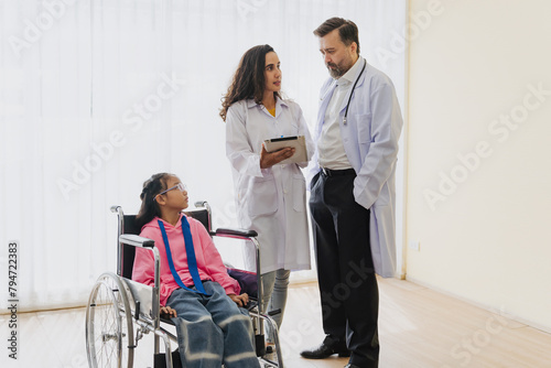 Nurse assisting wheelchair user in hospital