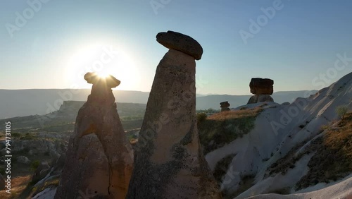 Cappadocia most popular view in sunrise. Turkey. Goreme National Park. Drone footage of red valley rocks formations called the Fairy Chimneys. Open air museum aerial shot of city and houses from caves photo