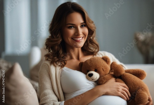 holding teddy sitting bear pregnant woman home Smiling sofa photo