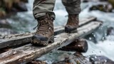 A hiker confidently crossing a wooden bridge over a river, wearing worn boots