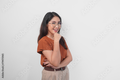 Side portrait of smiling beautiful Asian woman wearing brown shirt and eyeglasses isolated white background.