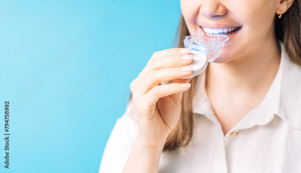 Lady inserts homemade teeth whitening equipment into mouth. Lady inserts homemade teeth whitening equipment into mouth.