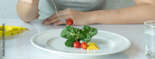 Boredom Young woman eat small portion of dinner meal during diet session