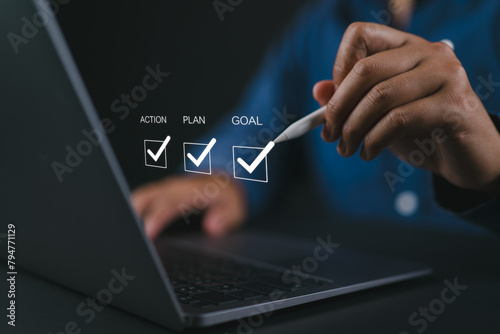 Goal, plan and action concept. Business strategy and business development. Businessman using laptop to checking mark on checkboxes on virtual screen..