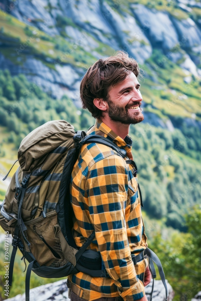Smiling Young Man on a Mountain Hike in Lush Green Landscape During Early Autumn