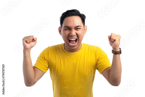 Excited handsome Asian man doing winner gesture with arms raised, shouting, celebrating success isolated on white background