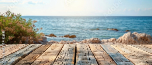 front view of empty raw wooden plank old table with blurred horizon ocean beach and cloudy blue sky background