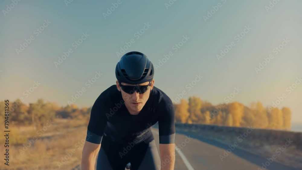 Cyclist training for leisure as he twists pedals on triathlon bicycle Cyclist training for leisure as he twists pedals on triathlon bicycle