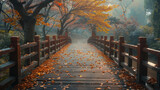 Wooden bridge covered with fallen autumn leaves in a misty, tranquil park.	