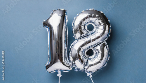 Banner with number 18 silver balloon. 18 years anniversary celebration. Blue background. photo