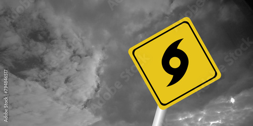 Hurricane Idalia warning sign against a powerful stormy background with copy space. Dirty and angled sign with cyclonic winds add to the drama.hurricane season sign on cloudy background
