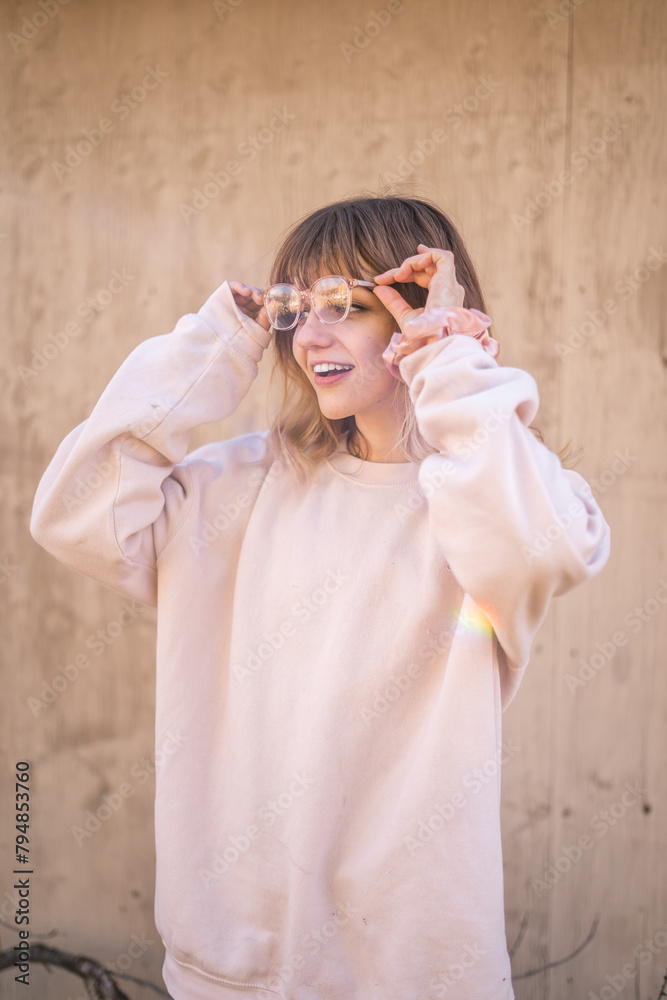 Girl Holding Eye Wear Wearing Oversized Soft Pink Crewneck Sweater Pink Glasses Smiling Teeth