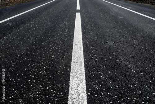 black asphalt road and white dividing lines
 photo