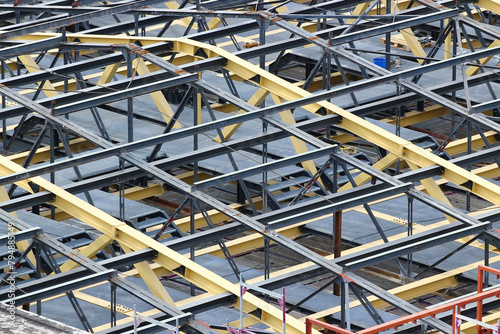 Steel trusses and beams of an unfinished roof, construction site background