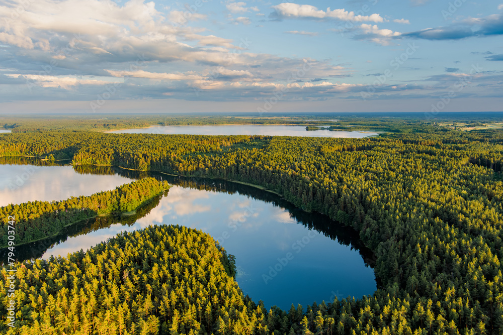 Scenic aerial view of Sciuro Ragas peninsula, separating White Lakajai and Black Lakajai lakes. Picturesque landscape of lakes and forests of Labanoras Regional Park, Lithuania.