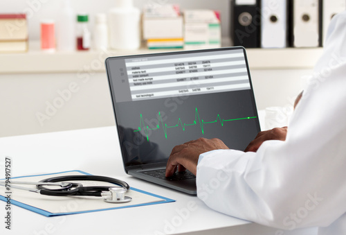 Cardiologist working with laptop at office. Health care concept © cunaplus