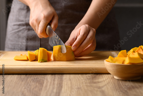 Organic pumpkin cutting on wooden board, Homemade cooking, Food ingredient