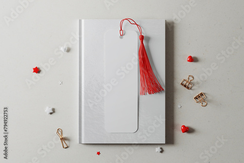 Bookmark with tassel on hardcover book mockup. 3D rendering