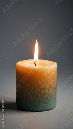 A beautifully burning thick  ornate candle.
