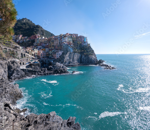 Cinque Terre, Italy - 13 Feb, 2024: Manarola, built on a high rock 70 metres above sea level, is one of the most charming and romantic of the Cinque Terre villages.  photo