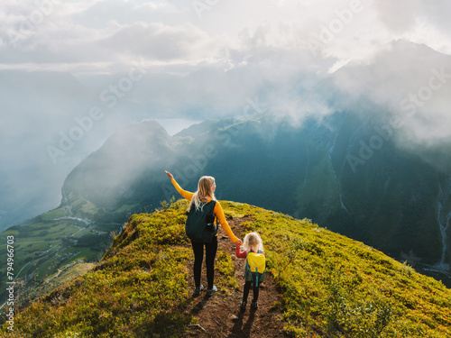 Family vacations in mountains - mother and child climbing in Norway together active summer adventure trip healthy lifestyle outdoor, woman hiking with daughter enjoying Sunnmore Alps landscape photo