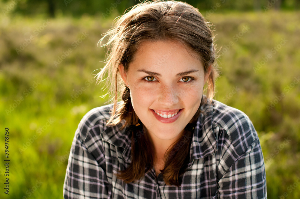 Woman, portrait and smile in grass field for spring with happiness, flowers and wellness. Female gen z person, rest and fresh air with relax by countryside for weather, farm environment and sunshine Woman, portrait and smile in grass field for spring with happiness, flowers and wellness. Female gen z person, rest and fresh air with relax by countryside for weather, farm environment and sunshine