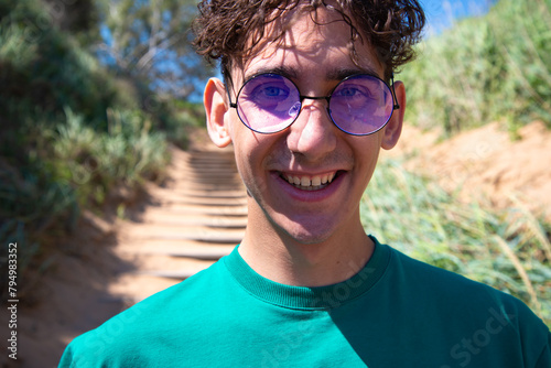 A young attractive man is photographed by the sea.
