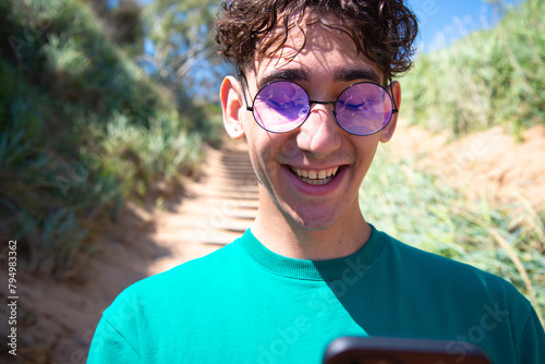 A young attractive man is photographed by the sea.