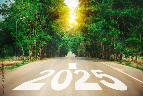New year 2025 or straight forward concept. Text 2025 written on the road in the middle of asphalt road with at sunset.