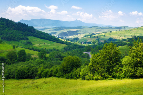 picturesque landscape of the rural valley and farmland scenery of ukraine. village and mountains in the distance. bright sunny weather in summer