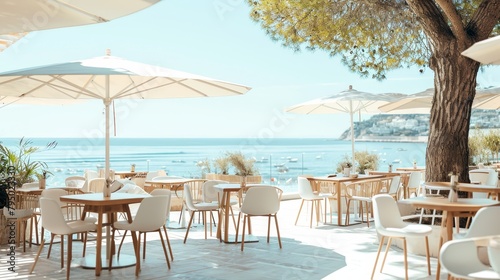 Fashionable beachside cafe with white and oak furnishings, where patrons enjoy panoramic views of the Riviera. The image exudes a chic, modern vibe with a touch of coastal sophistication.