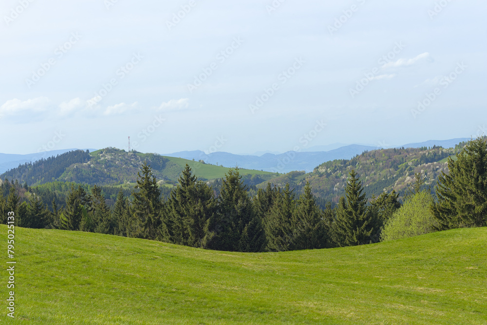 hilly landscape with blue skies in the background