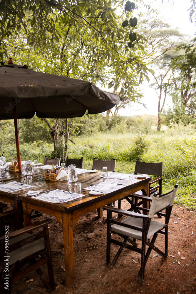 Fototapeta premium table set up for lunch outside at camp on safari in the Masai Mara in Kenya