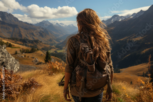 Woman travels in the mountains with a backpack.