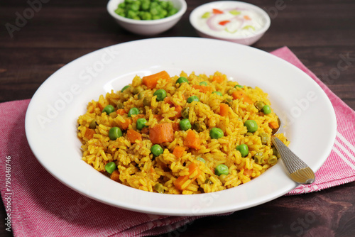 Carrots and Peas Pilaf or Gajar Matar Pulao. It is a one pot rice dish made with Basmati Rice and Vegetables, seasoned with spices, Served with yogurt raita or curd. Healthy weight loss meal. copy