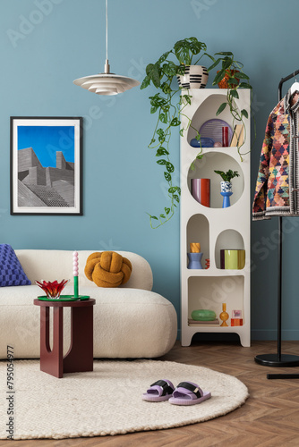 Interior desgin of modern living room interior with mock up poster frame, colorful decorations and accessories, plants, sofa, coffee table. Blue wall. Home decor. Template photo