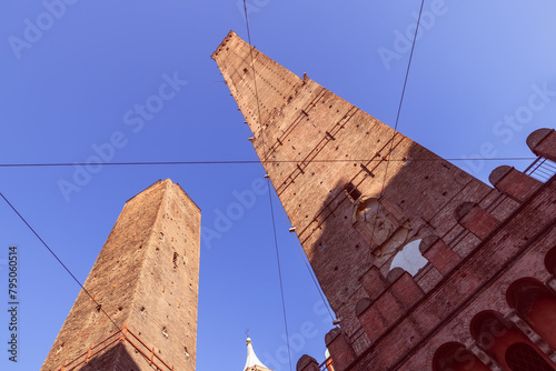 The medieval Two Towers of Bologna, Garisenda and Asinelli, stand as sentinels of time, their imposing brick facades a signature of the city skyline